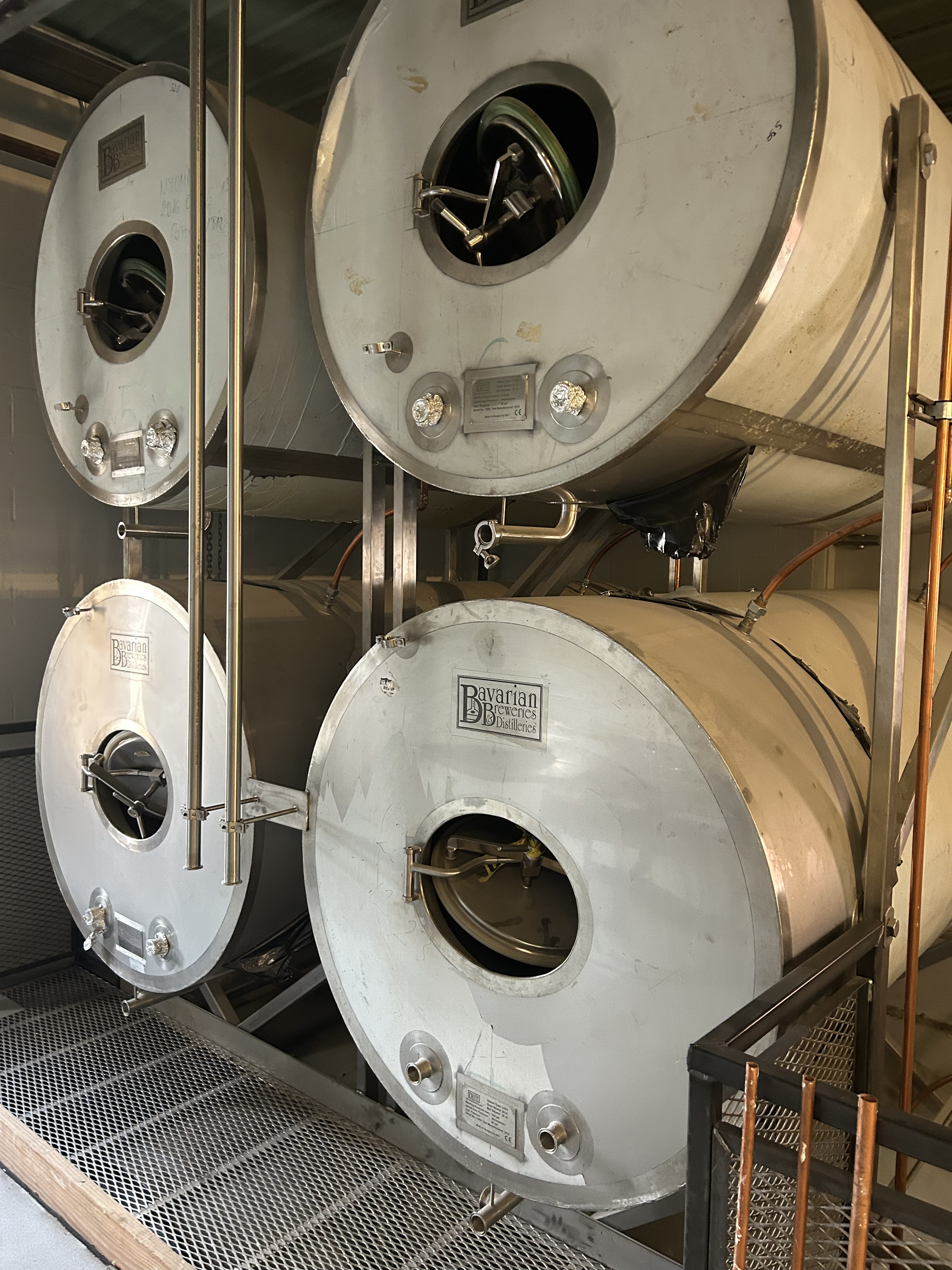 Close-up of BBT LH25 tanks installed horizontally in brewery with piping