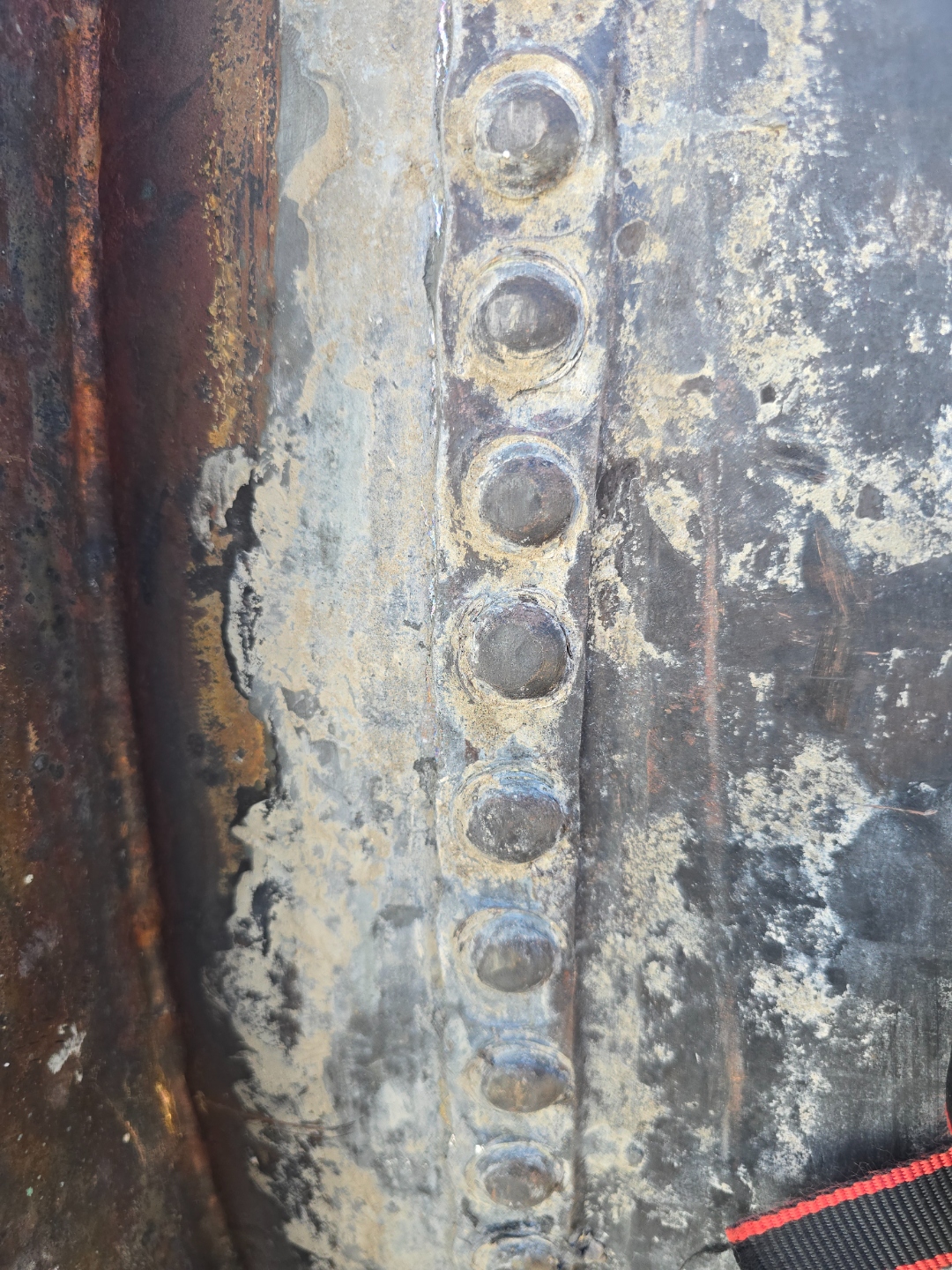 Close-up detail of hand-riveted copper seam construction